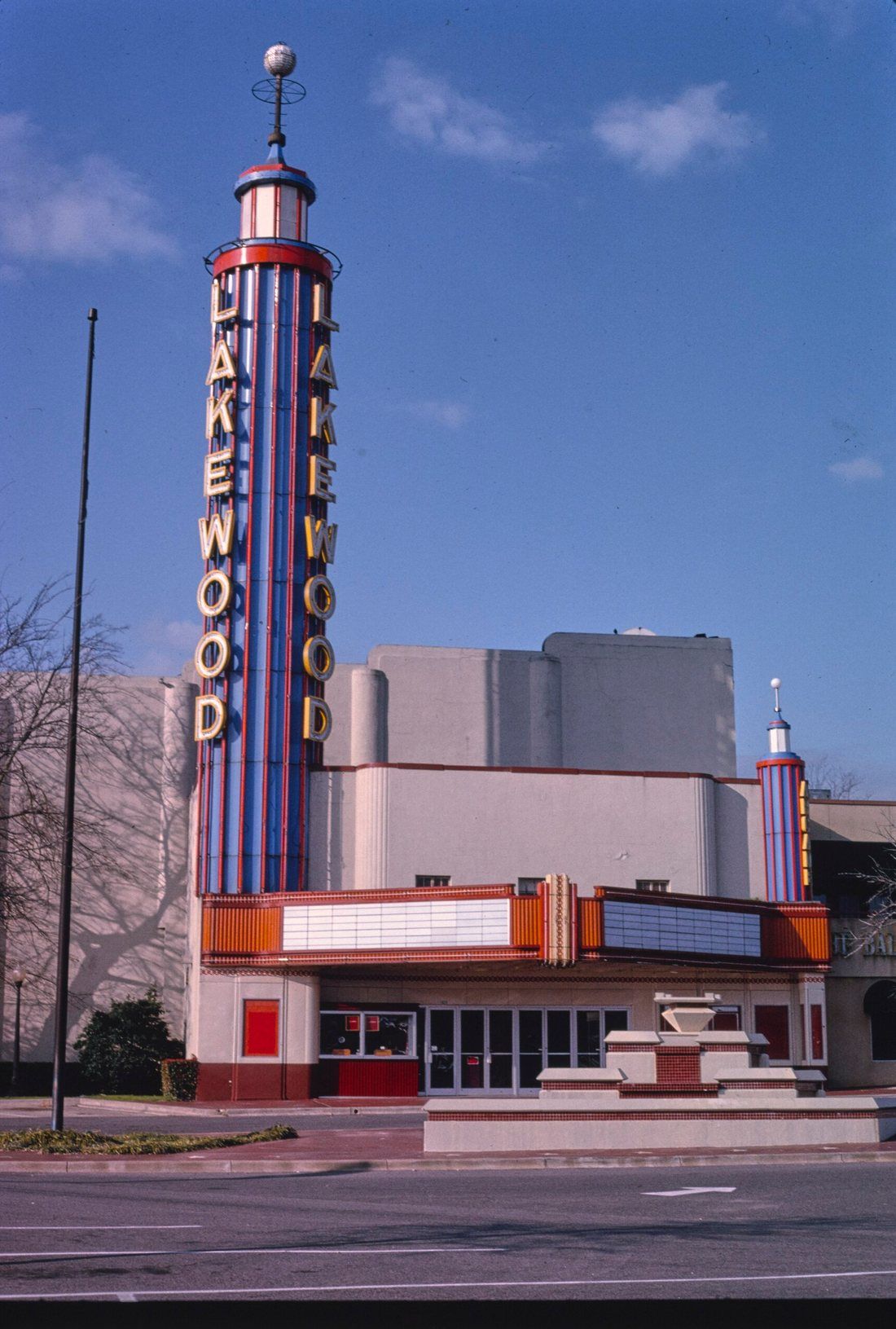 The Lakewood Theater with its neon sign tower and a blank marquee, photographed in the 1980s